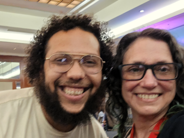 Dr. Marcus Fuller, smiling in glasses and a beige top, and Dr. Ganz, smiling in glasses and a navy top, at the awards ceremony for DADD 2026.