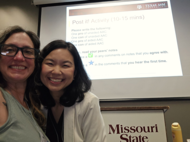 Dr. Birdie Ganz, smiling and wearing glasses and a light blue top, and Dr. Sanikan Wattanawongwan, smiling in a white jacket, at Dr. Wattanawongwan’s presentation at the 7th Annual 2025 Richard L. Simpson Conference on Autism at Missouri State University.