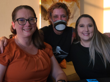 Drs. Trudy Georgio in an orange blouse and glasses, Ganz in a black top and K95, and Shanna Bodenhamer in a black top at the 2022 Richard L. Simpson Conference on Autism in Kansas